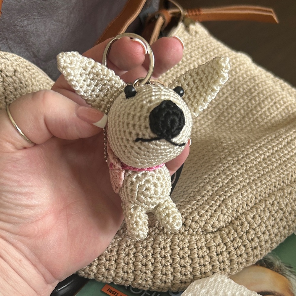 The Sak Cream Crochet Dog Keychain with Pink Collar Accent